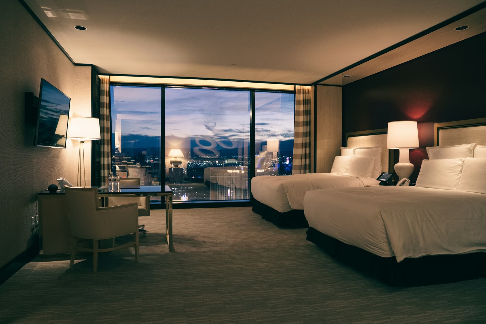 Hotel suite overlooking city lights at dusk