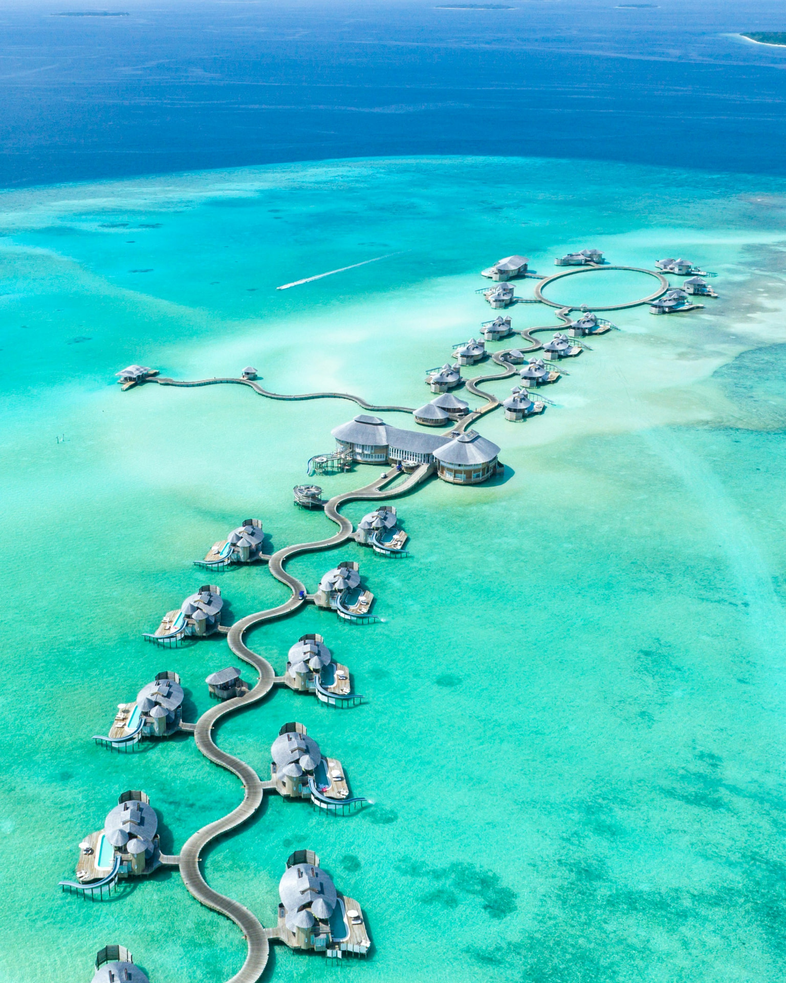 Overwater villas winding across a turquoise lagoon