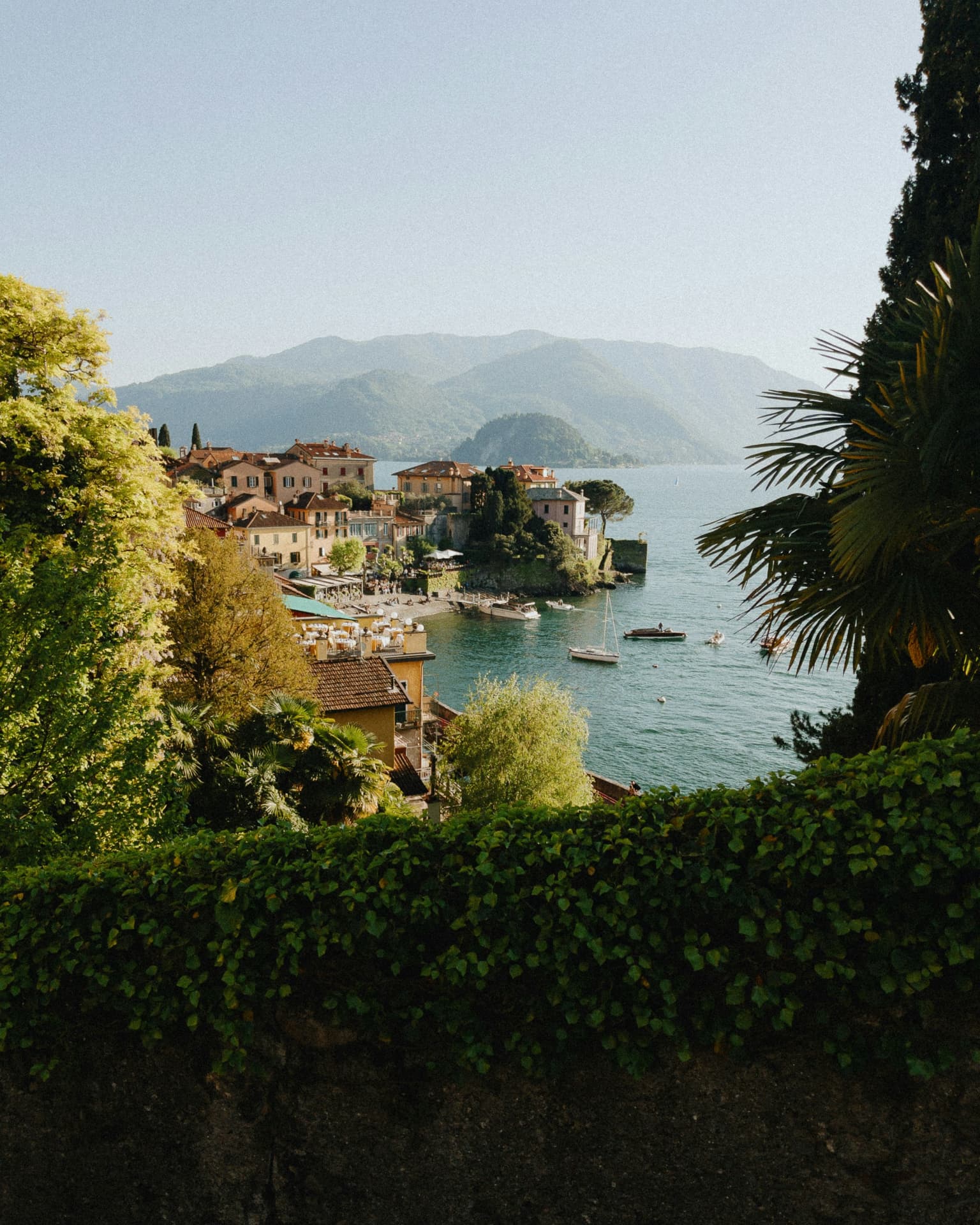 Lakeside village beneath misty mountains